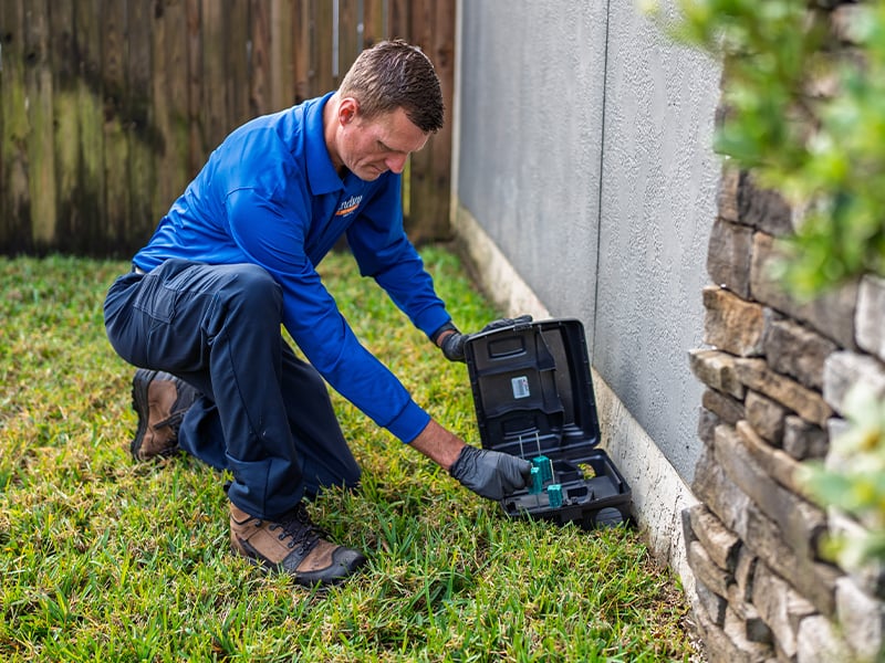 pest control specialist checking rodent station