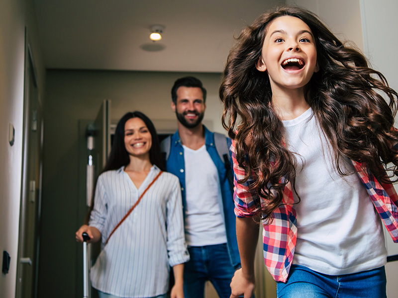 family entering hotel room
