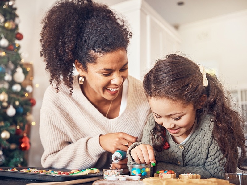 mom and daughter baking christmas cookies in jacksonville