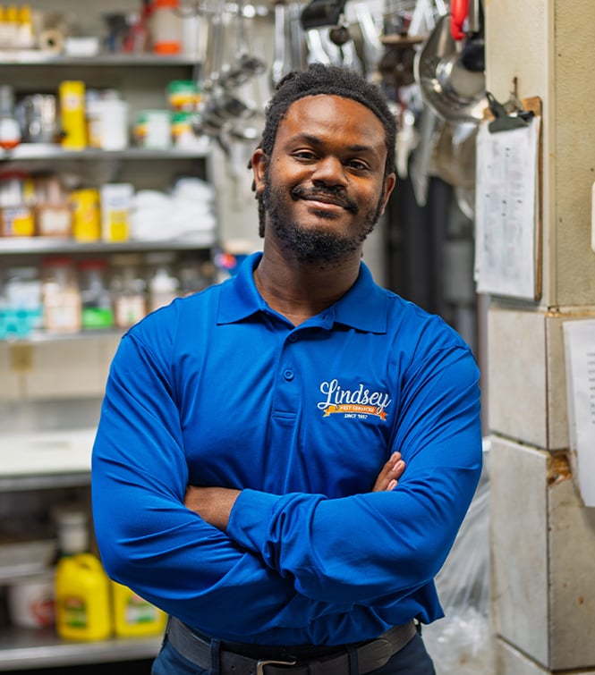 a technician standing with his arms crossed in a florida business