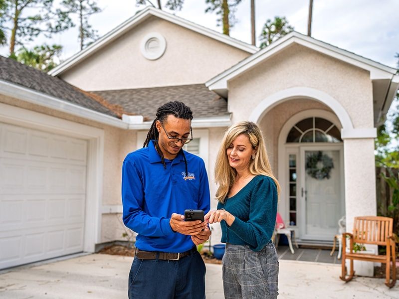 pest control technician explaining rodent control plan to homeowner