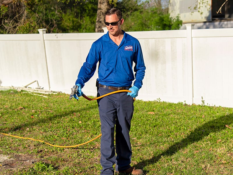 lindsey service tech treating lawn for fleas