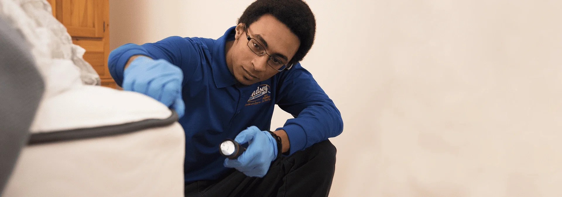 a pest technician inspecting a jacksonville residence for bed bugs