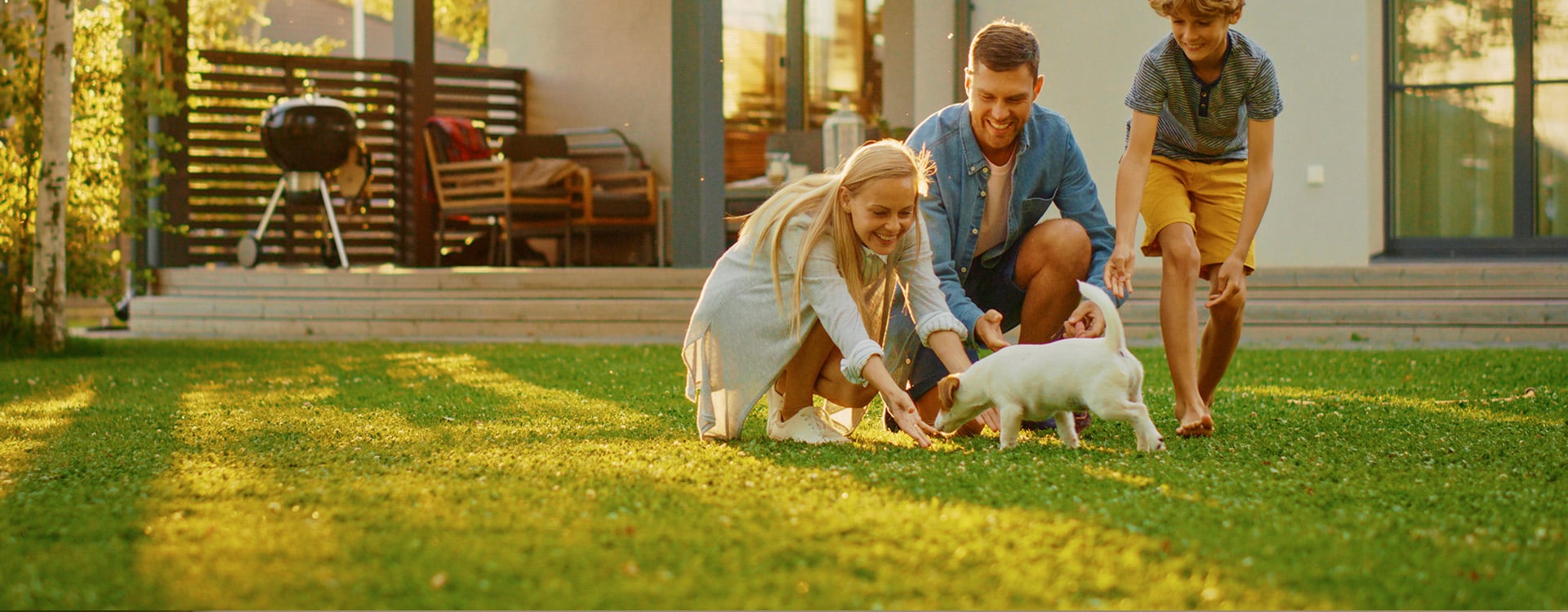 family in yard with pet