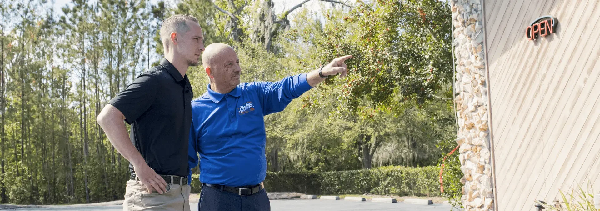 a pest control technician and property manager inspecting a building in asbury lake florida