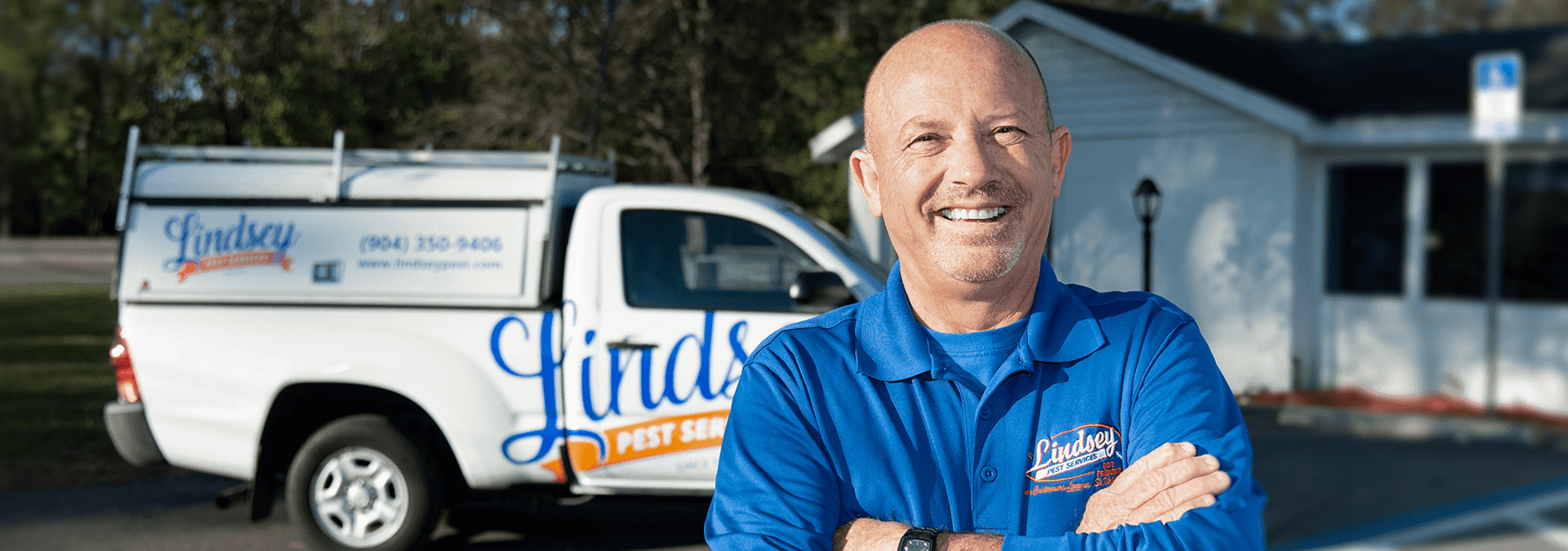 a lindsey pest technician standing in front of his truck in neptune beach florida