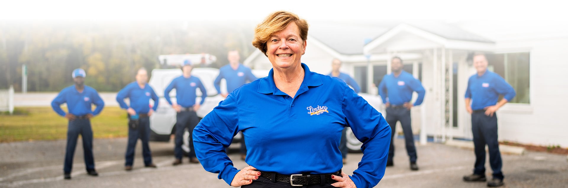 the team of lindsey pest professionals standing outside of their office in florida