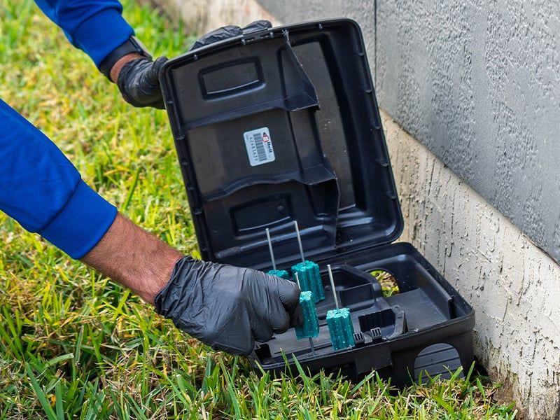 lindsey tech checking a rodent bait station