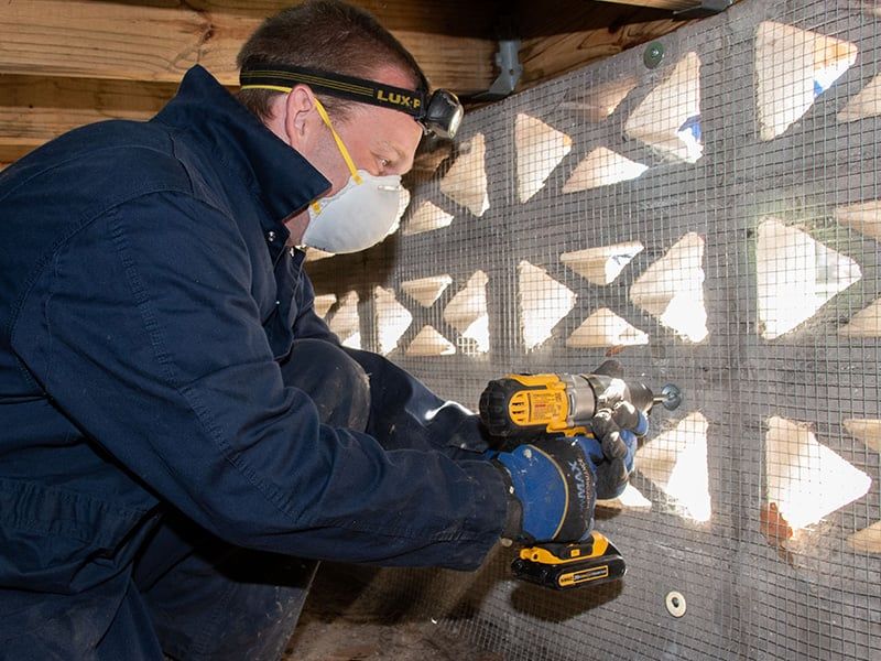 lindsey technician under house pest-proofing for rodents