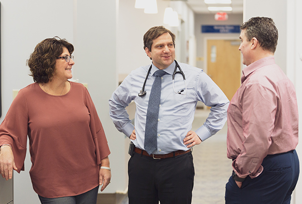 Dr. John Winters speaking with John and his wife, Janice