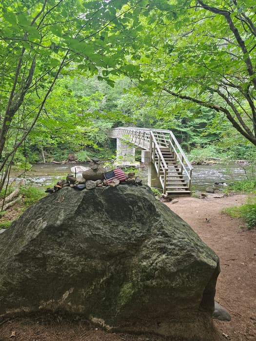 memorial stone on the trail and a footbridge over the Shepaug River