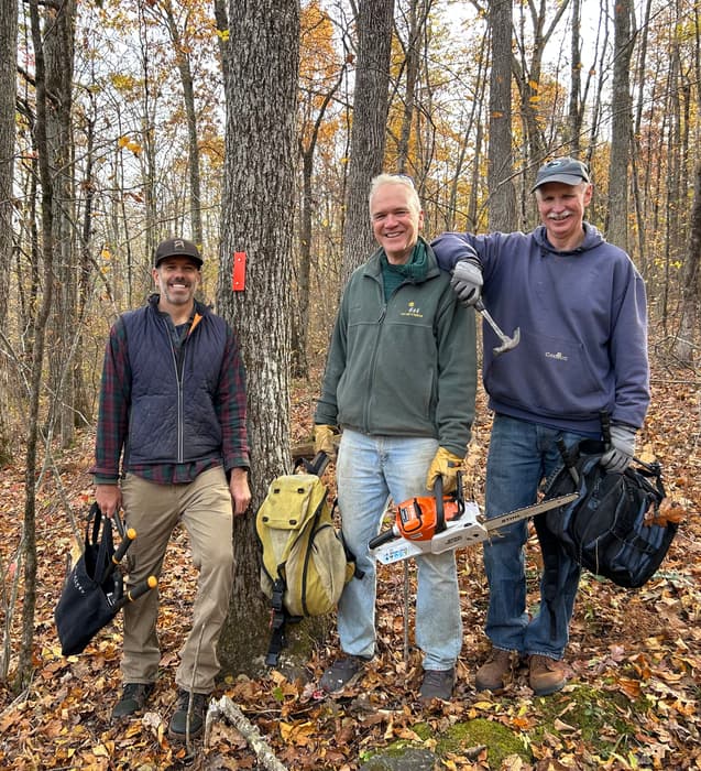 Trail crew posing near an orange blaze (Credit: Dean Birdsall)