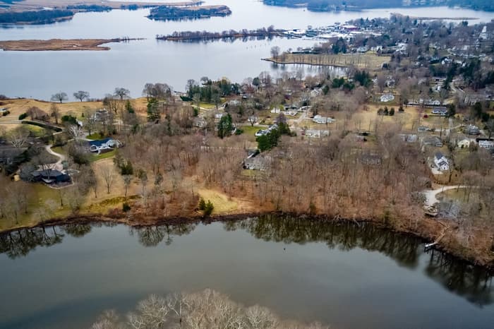 An aerial view looking south from North Cove. In the center foreground the grassy area along the shoreline is Osage Preserve.