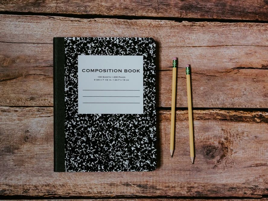 notebook and pencils on a desk