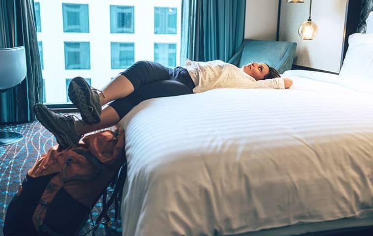 woman laying on hotel bed