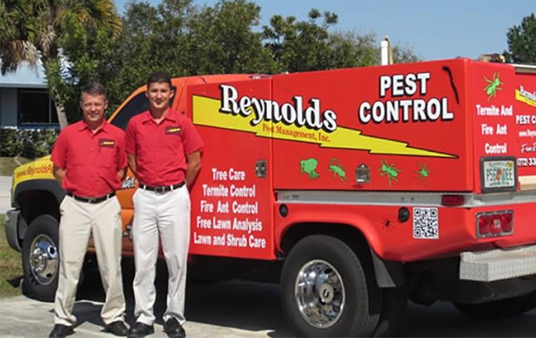 owners with pest control service truck in Jupiter Florida