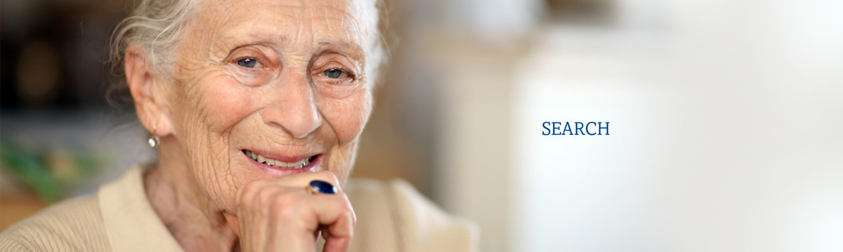 An older woman smiles. We offer friendly visitation and help for isolated seniors and disabled indviduals.