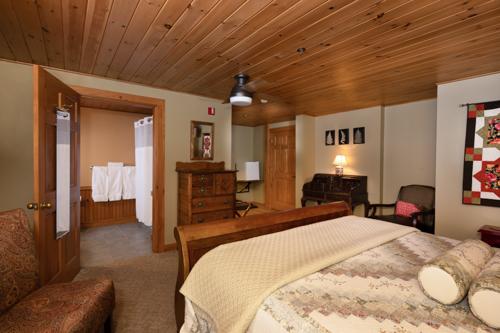 A bed and a dresser in a beige painted room