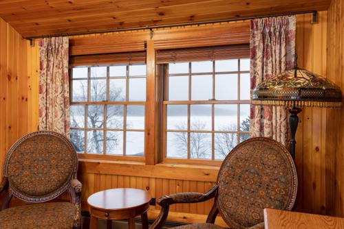 Two chairs and a window in a wood paneled room