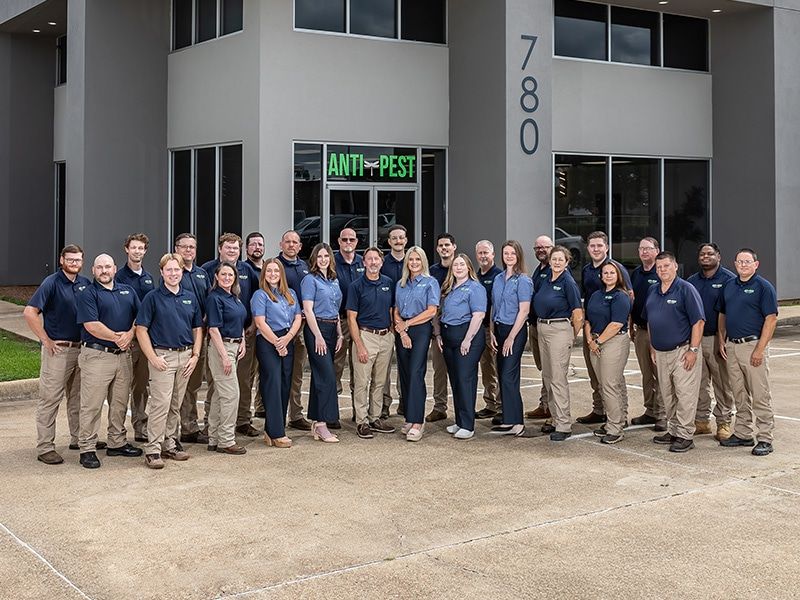 anti-pest employee photo in front of office