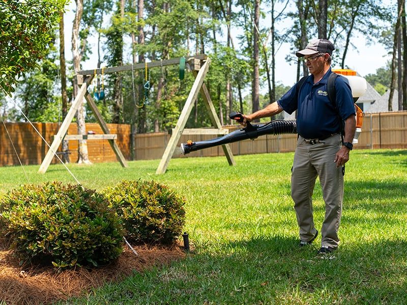 mosquito technician from anti-pest spraying a yard