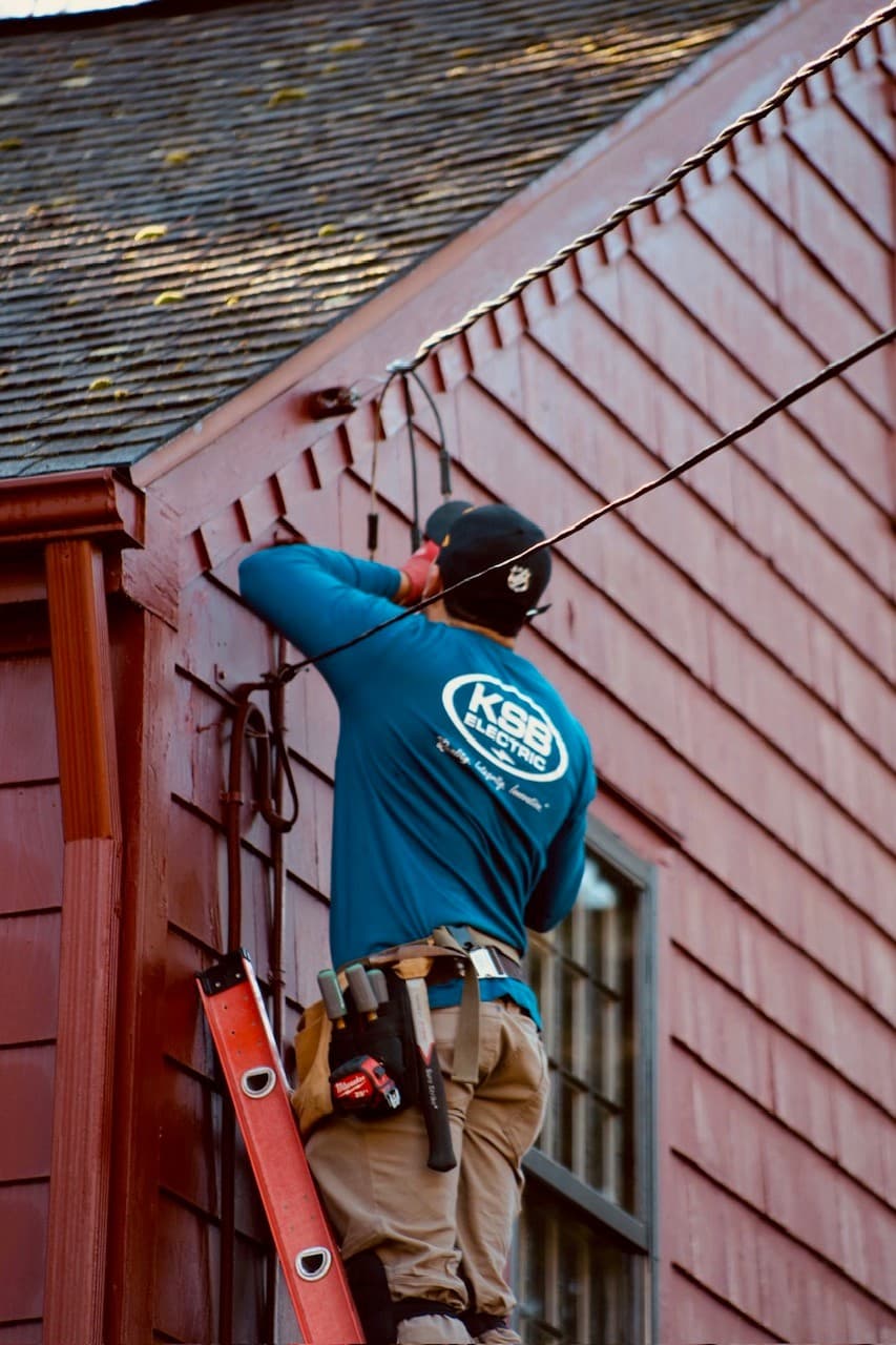 Person on a ladder against a house