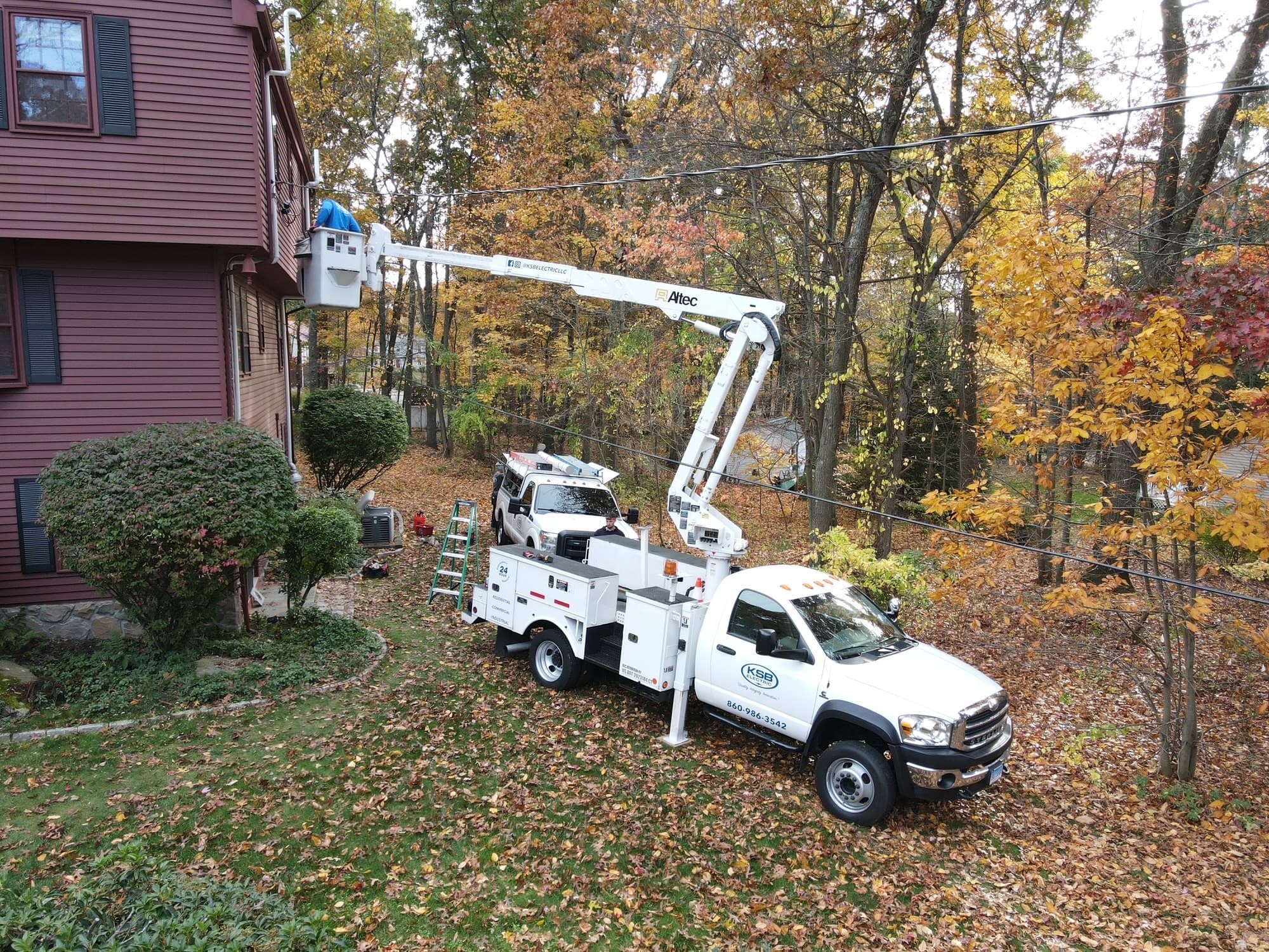 white trucks outside a red house