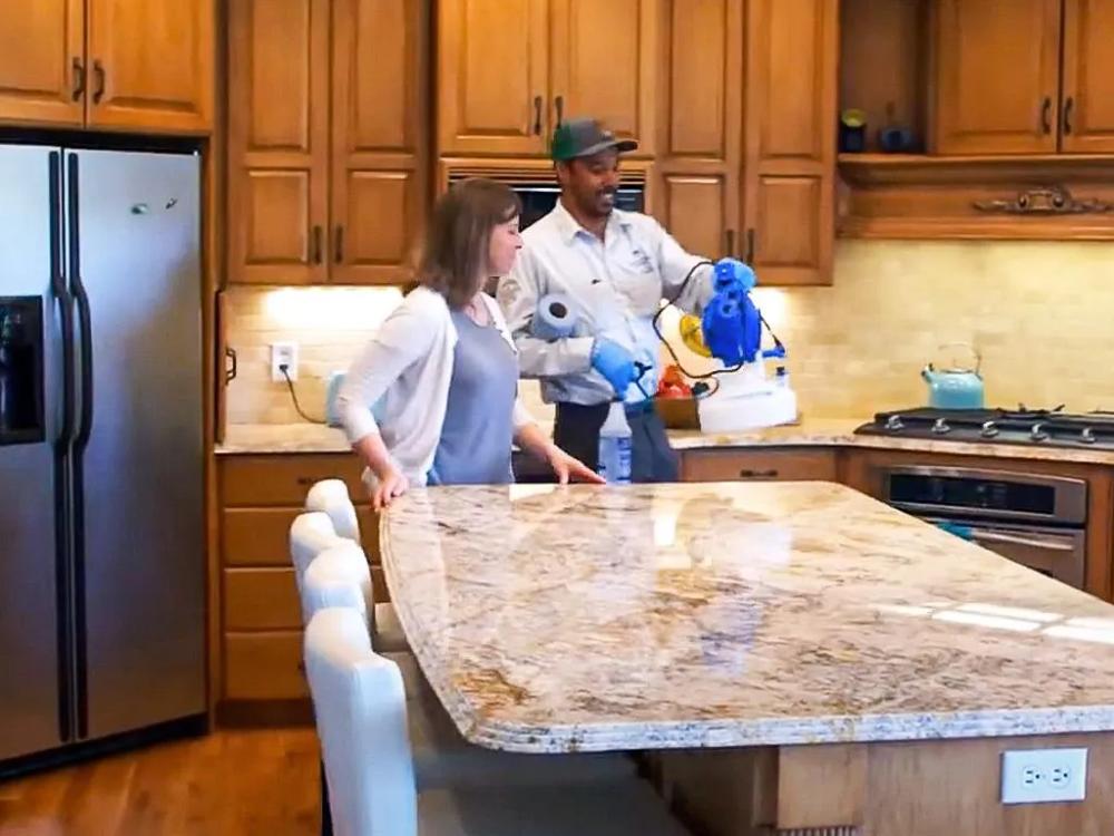 sanitation specialists discussing treatment with New Mexico homeowner