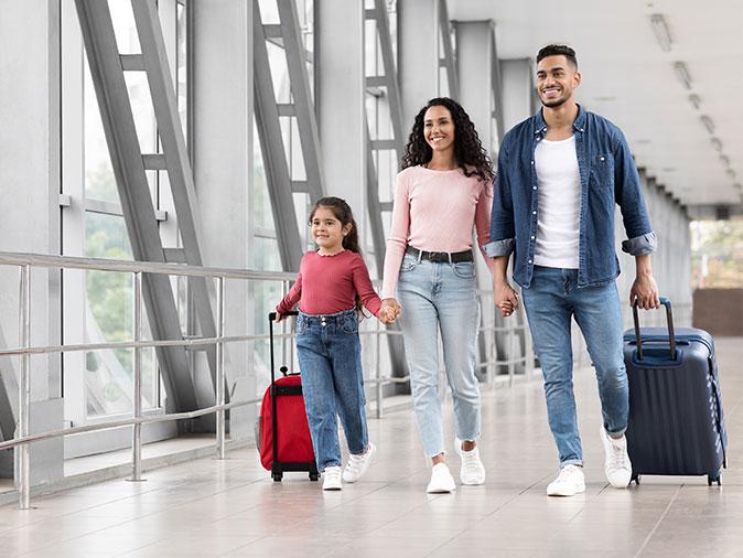 family walking through airport