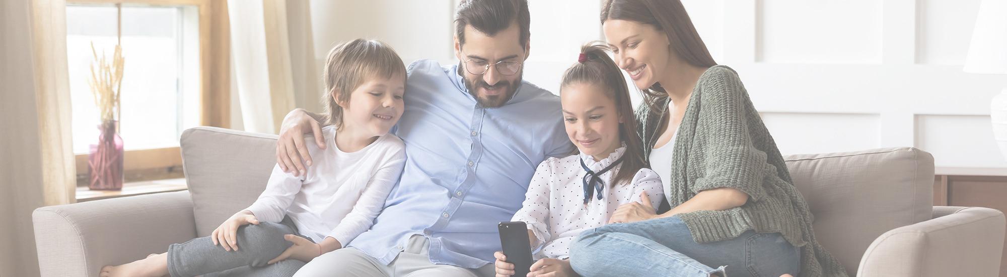 A family on couch with their children.