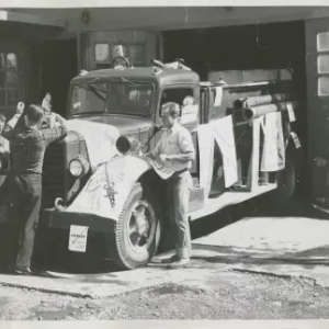 Black and White Photo of people in front of a truck