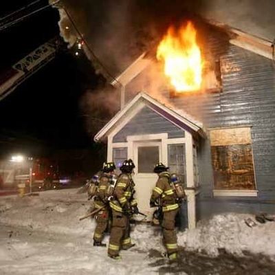 Firefighters and house on fire
