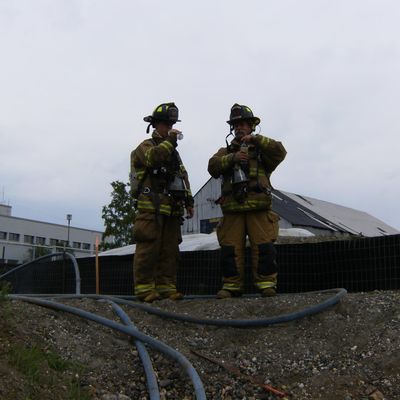 Two firefighters drinking water