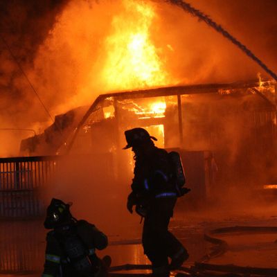 Building on fire and firefighters