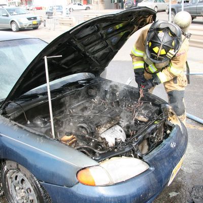 Firefighter working on car
