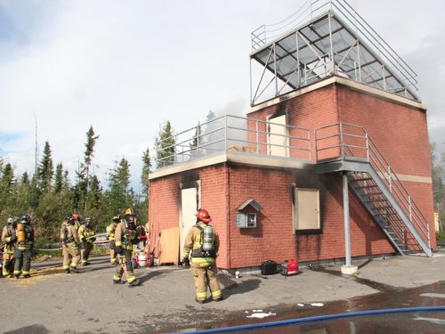 Firefighters and a brick building