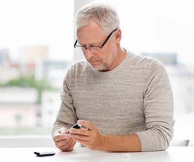 diabetic man checking blood sugar