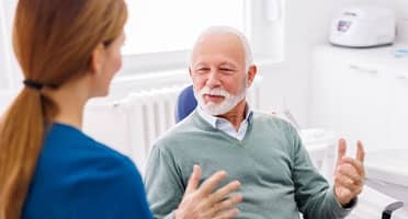 dentist discusses sleep apnea treatment with patient