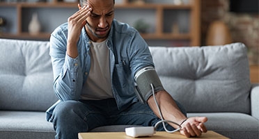 middle aged man checking blood pressure