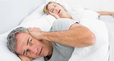 man can't sleep because of wife's snoring