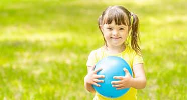 little girl playing with ball