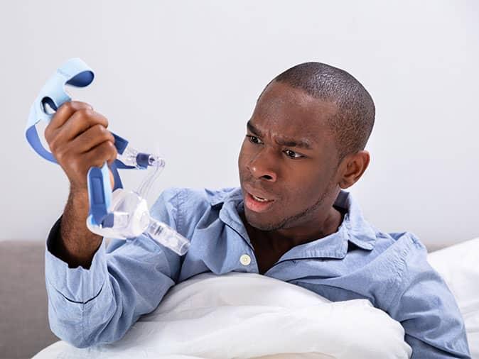 man looking at his cpap equipment