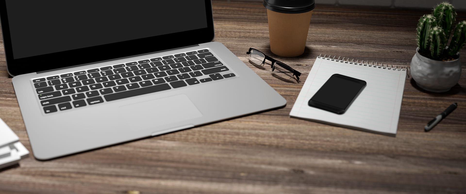 a laptop and phone on a desk in columbia south carolina