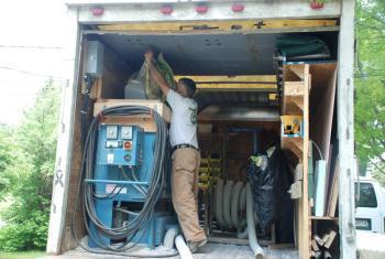A man getting tools from a box truck