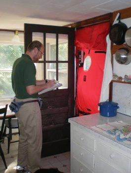 A man inspecting a house