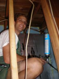 A man smiling while working in a crawlspace