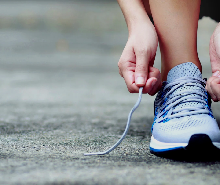 person tying running shoes