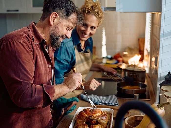 couple making thanksgiving meal for family