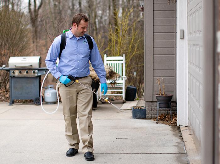 exterminator treating outside of house