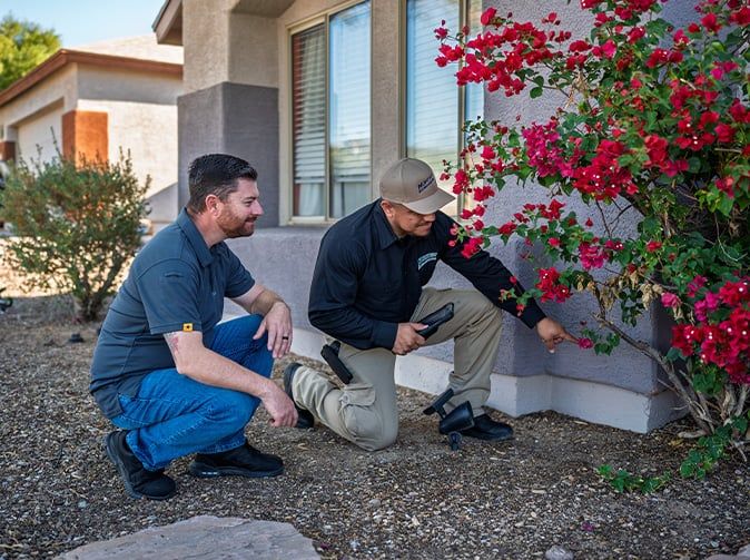 pest control technician inspecting a home in arizona